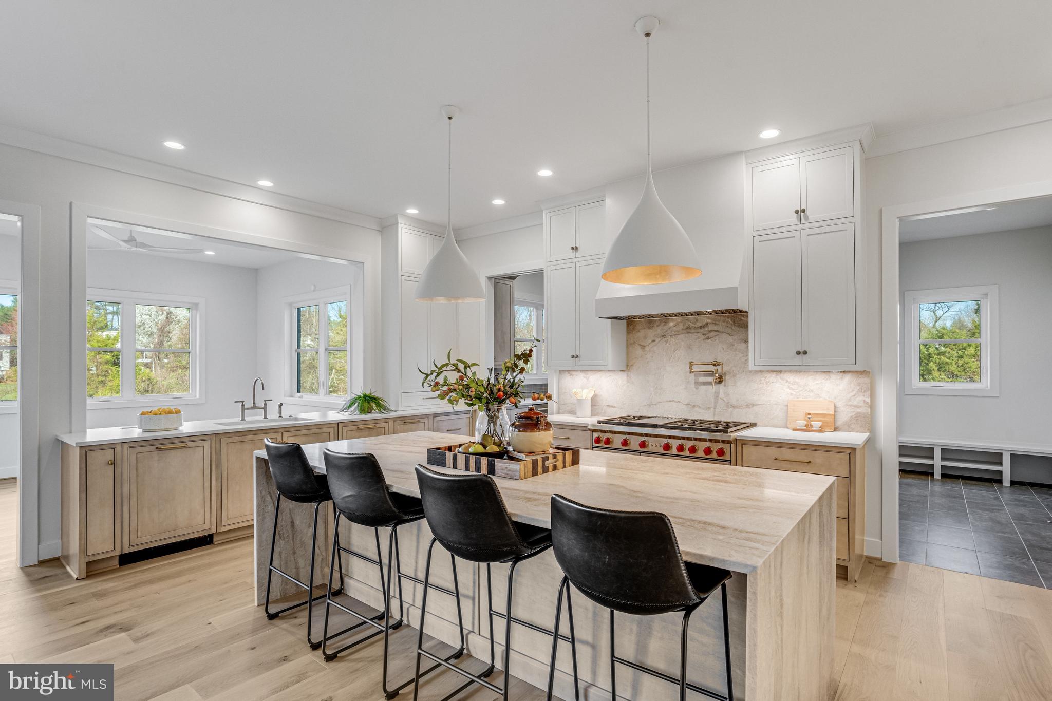 1002 Springvale Road Great Falls, VA 22066 - Photo 38 of 114 a kitchen with stainless steel appliances a stove a sink a refrigerator a dining table and chairs