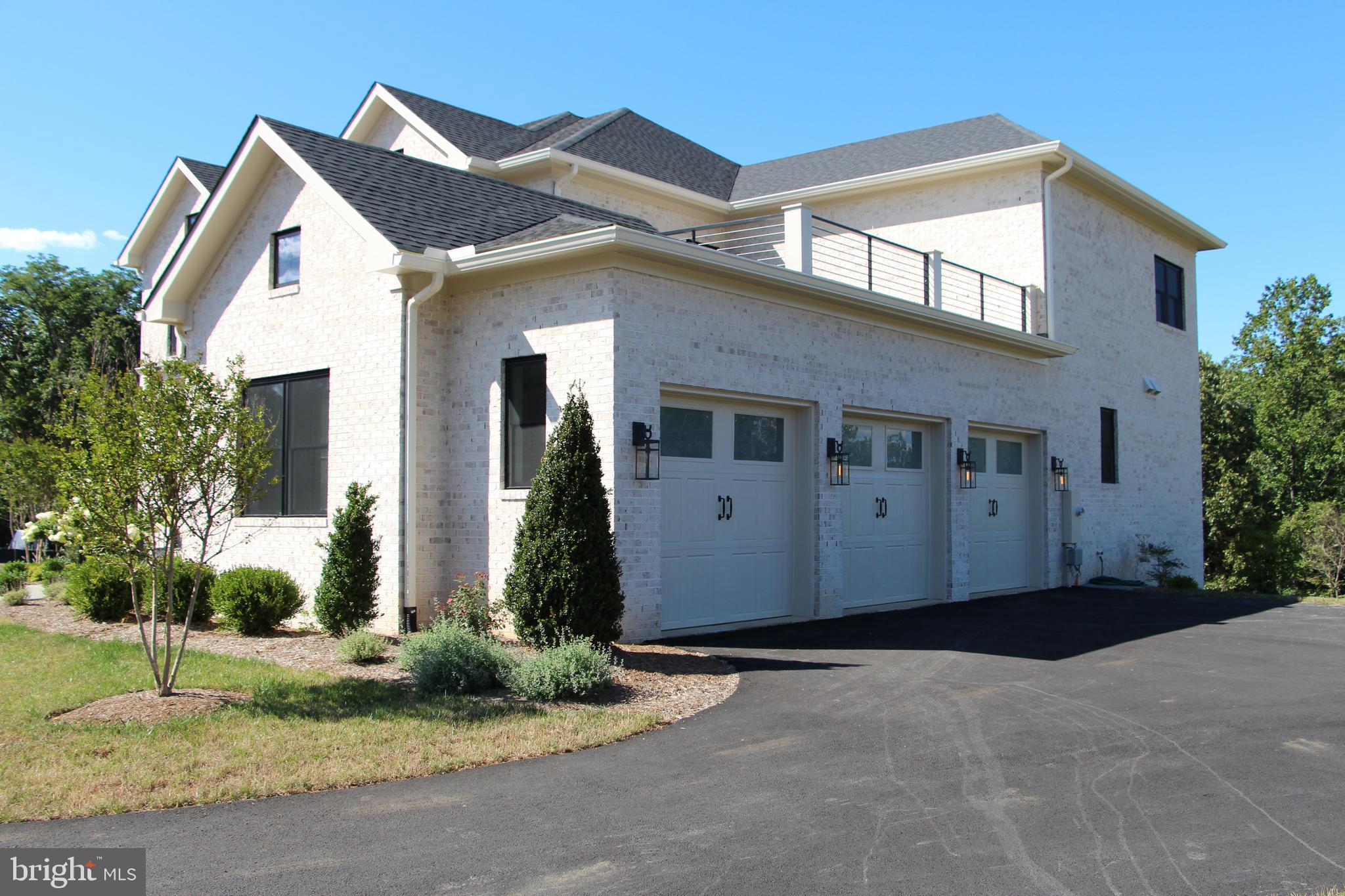 1002 Springvale Road Great Falls, VA 22066 - Photo 46 of 52 a front view of a house with garden