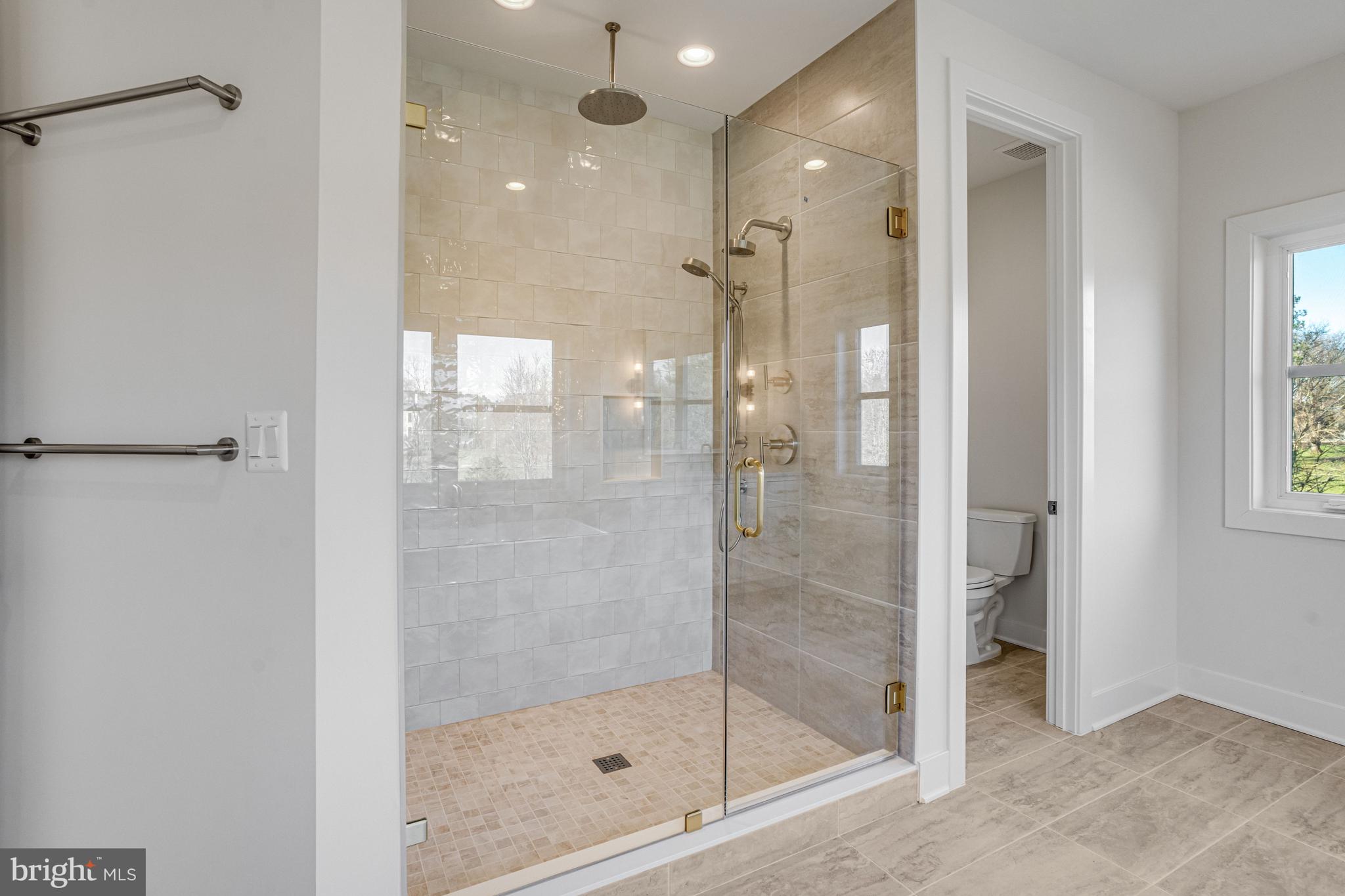 1002 Springvale Road Great Falls, VA 22066 - Photo 93 of 114 a bathroom with a glass shower door