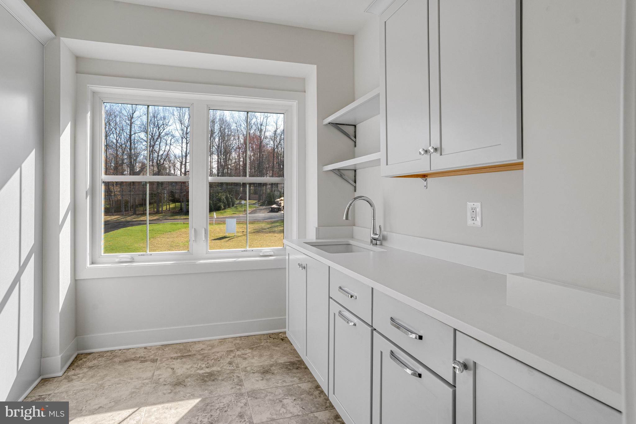 1002 Springvale Road Great Falls, VA 22066 - Photo 95 of 114 a kitchen with white cabinets and a window