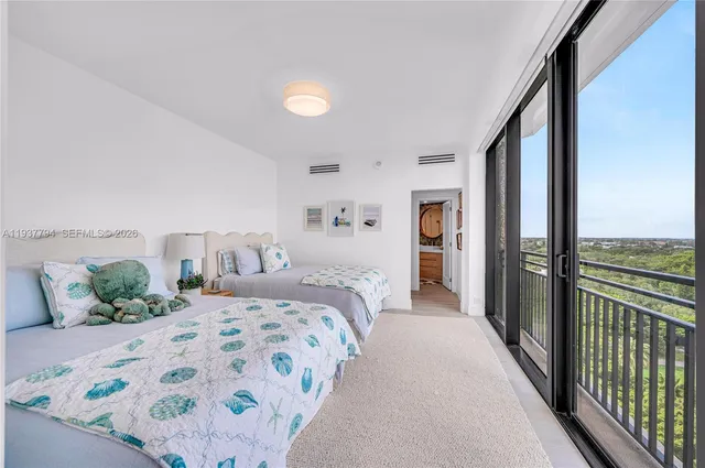 a bedroom with a bed and a view of balcony