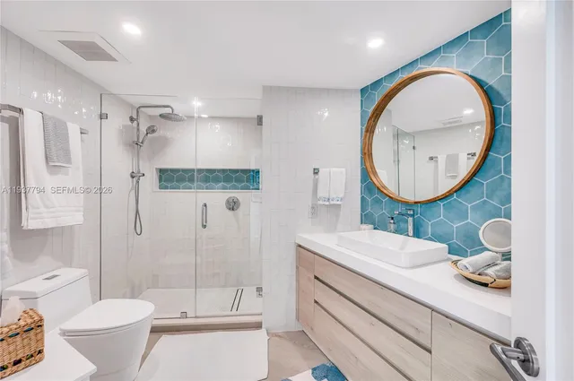 a bathroom with a toilet a sink and a mirror