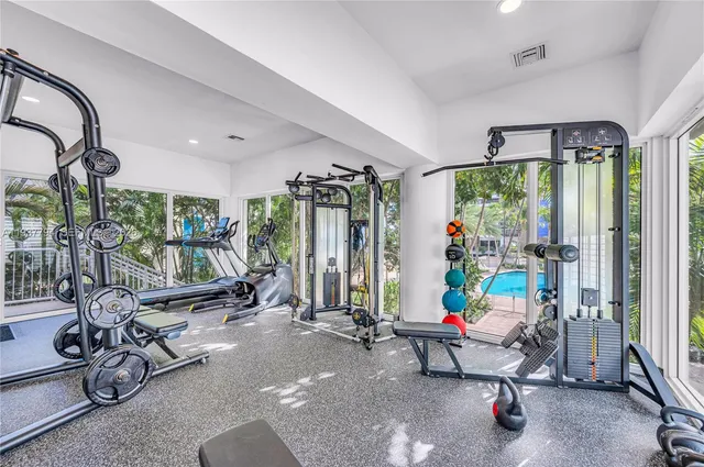 a view of a room with gym equipment and windows
