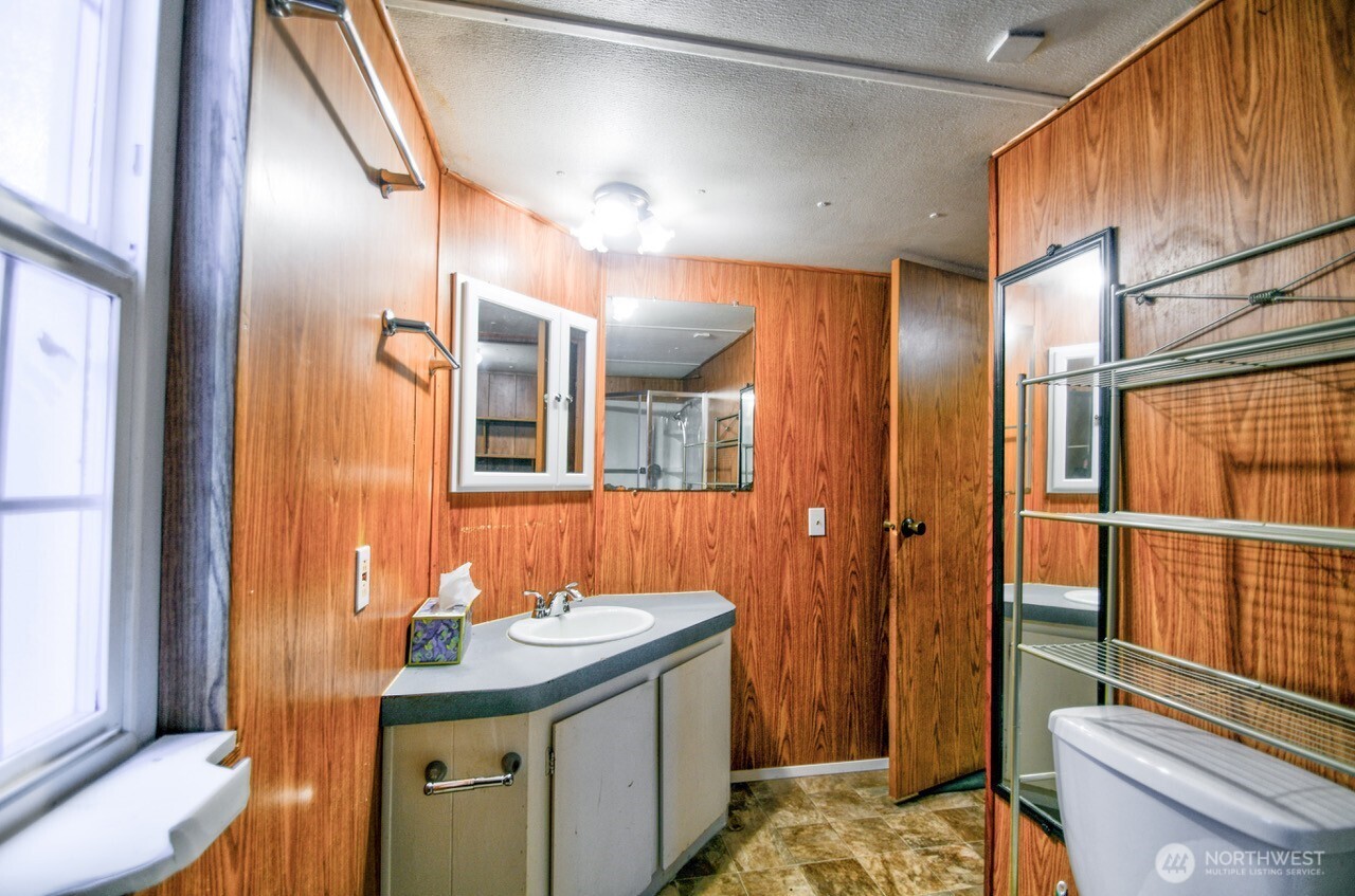220 West Buck Prairie Road Elma, WA 98541 - Photo 13 of 30 a bathroom with a sink and a mirror