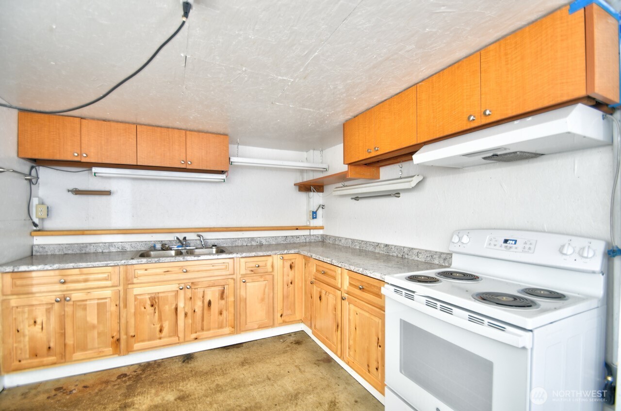 220 West Buck Prairie Road Elma, WA 98541 - Photo 21 of 30 a kitchen with a stove a sink and a microwave