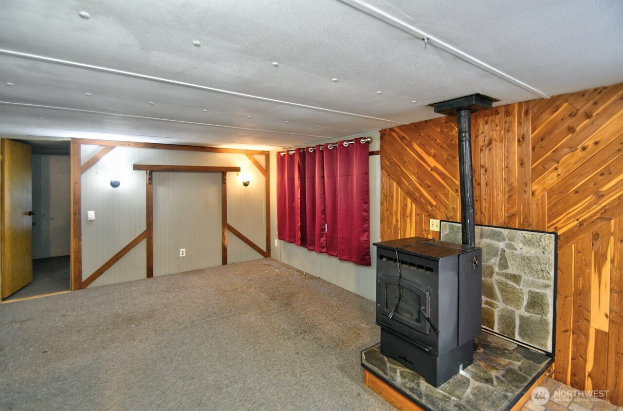 220 West Buck Prairie Road Elma, WA 98541 - Photo 5 of 30 a view of an empty room with wooden floor and a window
