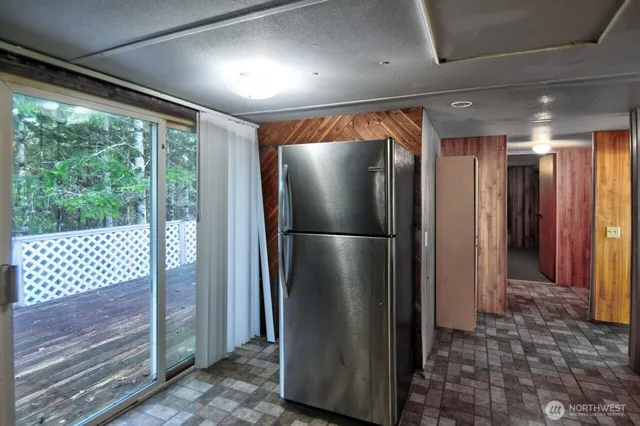 a metallic refrigerator freezer sitting in a kitchen