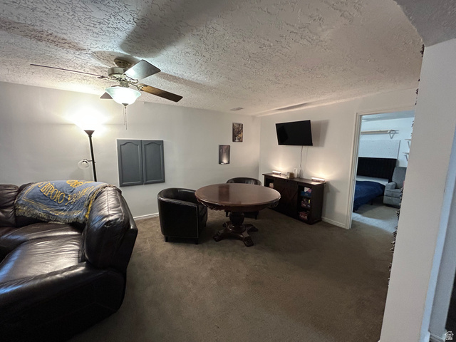 7659 State Street Midvale, UT 84047 - Photo 16 of 33 Carpeted living room with a textured ceiling and ceiling fan