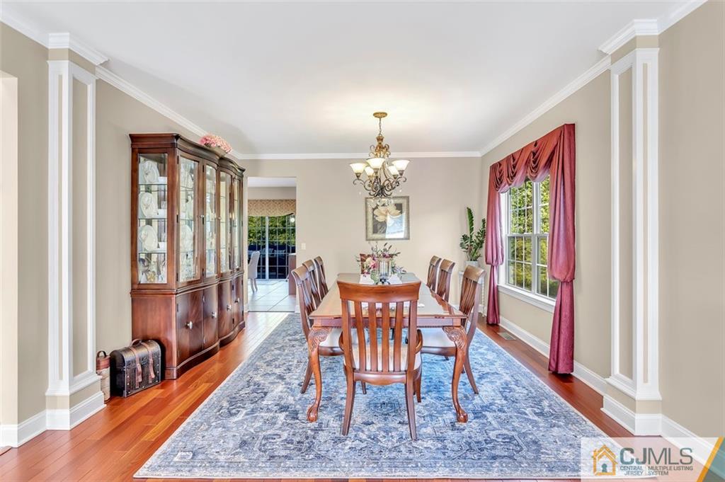 87 Willocks Circle Somerset, NJ 08873 - Photo 12 of 31 a dining room with furniture a rug and wooden floor