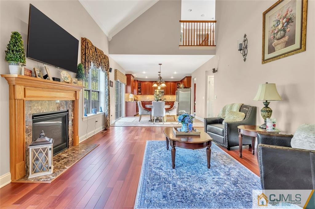 87 Willocks Circle Somerset, NJ 08873 - Photo 14 of 31 a living room with fireplace furniture and a flat screen tv
