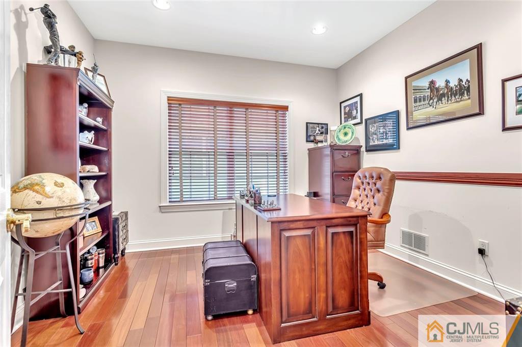 87 Willocks Circle Somerset, NJ 08873 - Photo 23 of 31 a living room with furniture a piano and a bookshelf