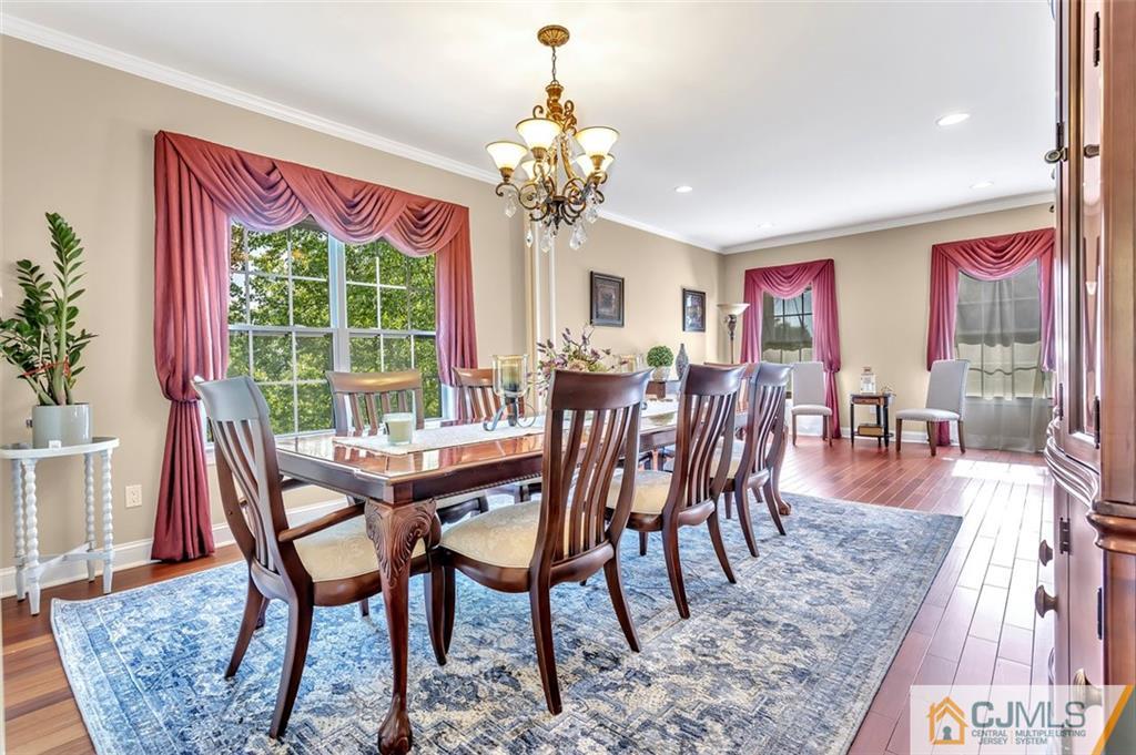 87 Willocks Circle Somerset, NJ 08873 - Photo 10 of 31 a dining room with furniture a chandelier and wooden floor