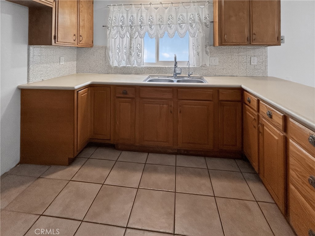 7451 Diamond Street Riverside, CA 92504 - Photo 6 of 31 a kitchen with a sink a stove and cabinets