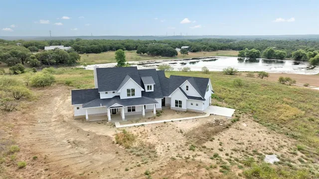 a view of a lake with a table and chairs
