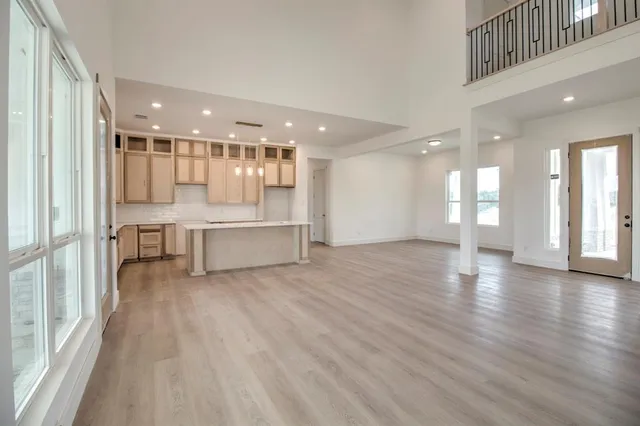a living room with stainless steel appliances furniture and large windows