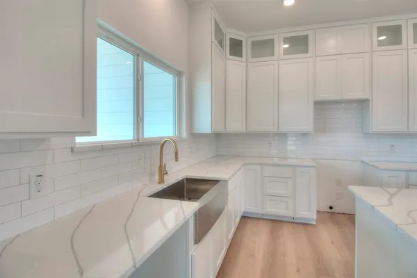 a kitchen with a sink cabinets and window