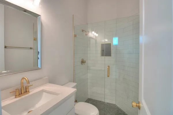 a bathroom with a sink toilet and shower