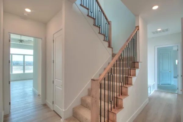 a view of entryway and hall with wooden floor