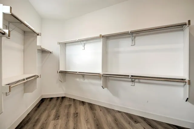 a white bath tub sitting next to a white sink and a mirror