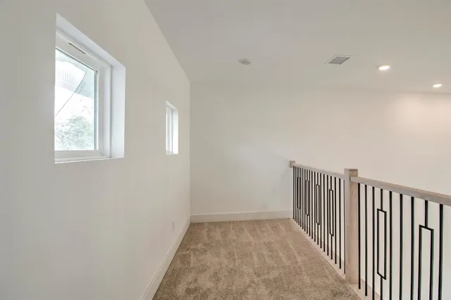 an empty room with windows and entrance