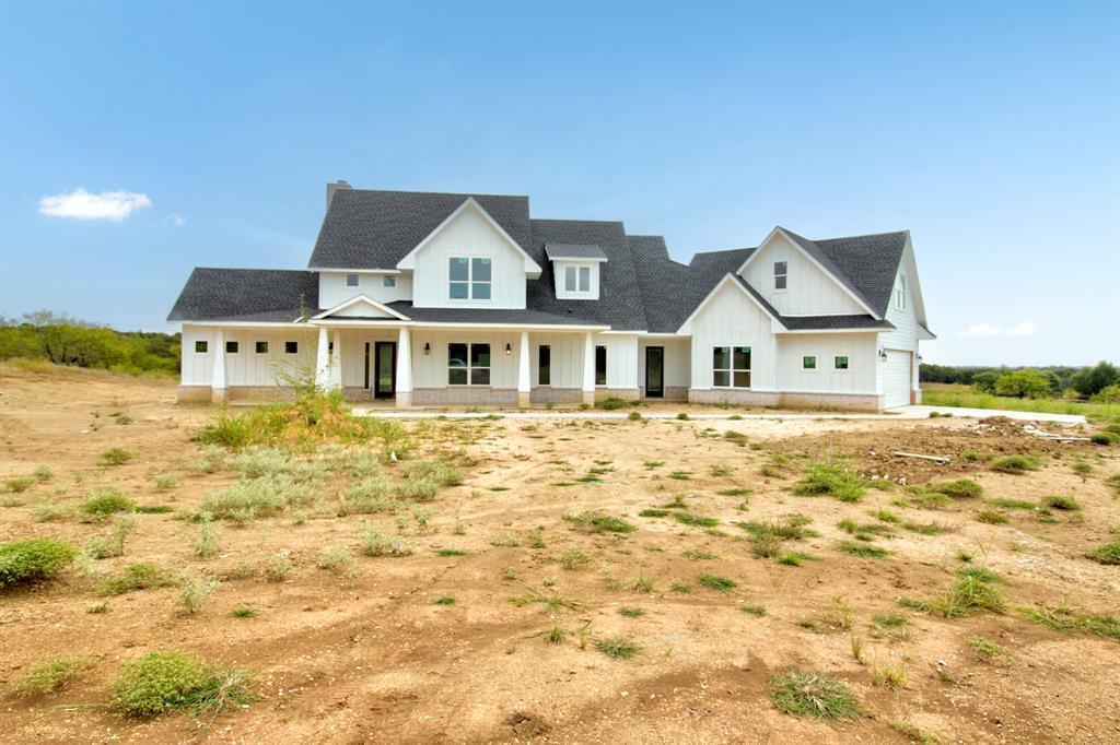 117 Mustang Springs Circle Sunset, TX 76270 - Photo 4 of 40 Modern inspired farmhouse with covered porch, board and batten siding, a shingled roof, and an attached garage