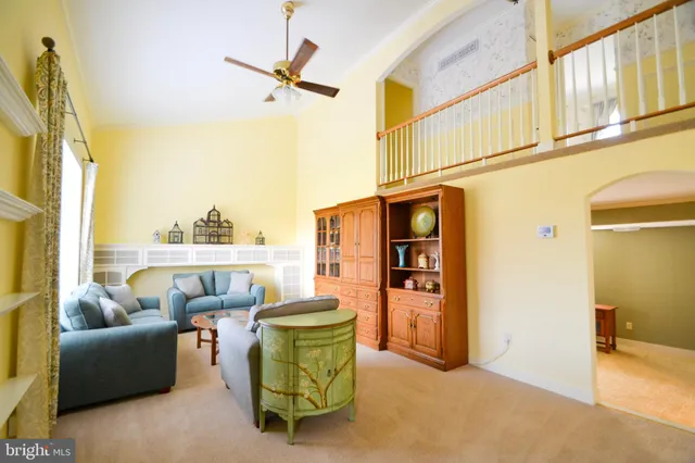 a living room with furniture a window and a flat screen tv