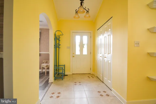 a view of a hallway with wooden shelves