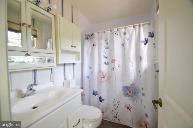 a view of a hallway with a ceiling fan and a window