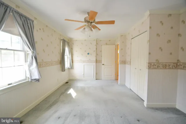 a view of a room with a ceiling fan