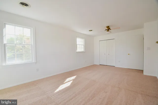 a bathroom with a granite countertop shower a sink and a toilet
