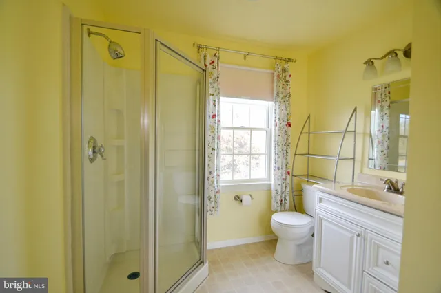 an empty room with a ceiling fan and a window