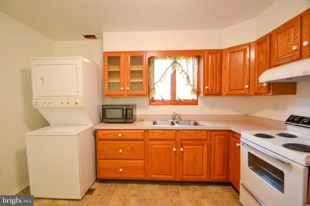 a kitchen with a white stove and refrigerator