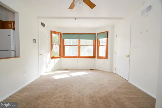 a view of a room with a ceiling fan