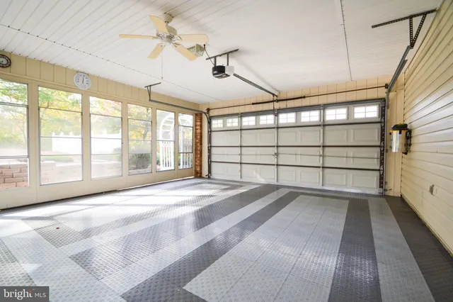 a view of a house with backyard and a tree
