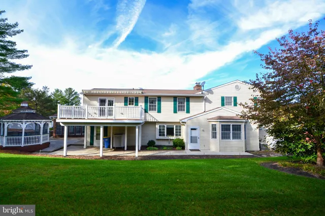 a view of a house with a yard and sitting area