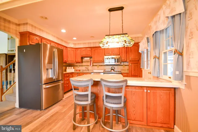 a kitchen with stainless steel appliances a refrigerator and a stove