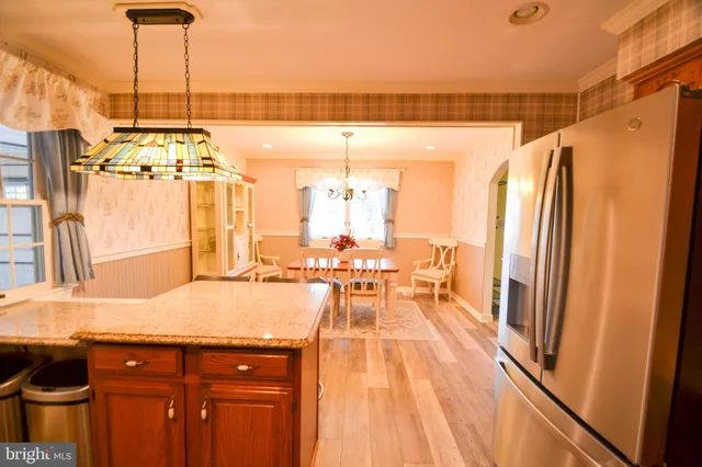 a very nice looking dining room with a large window and chandelier