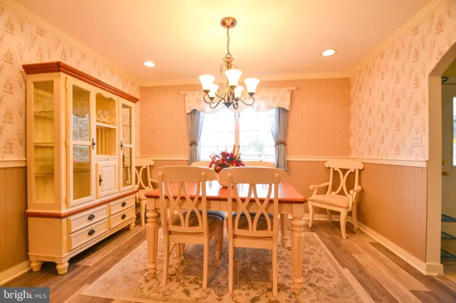 a view of a dining room with furniture and a chandelier