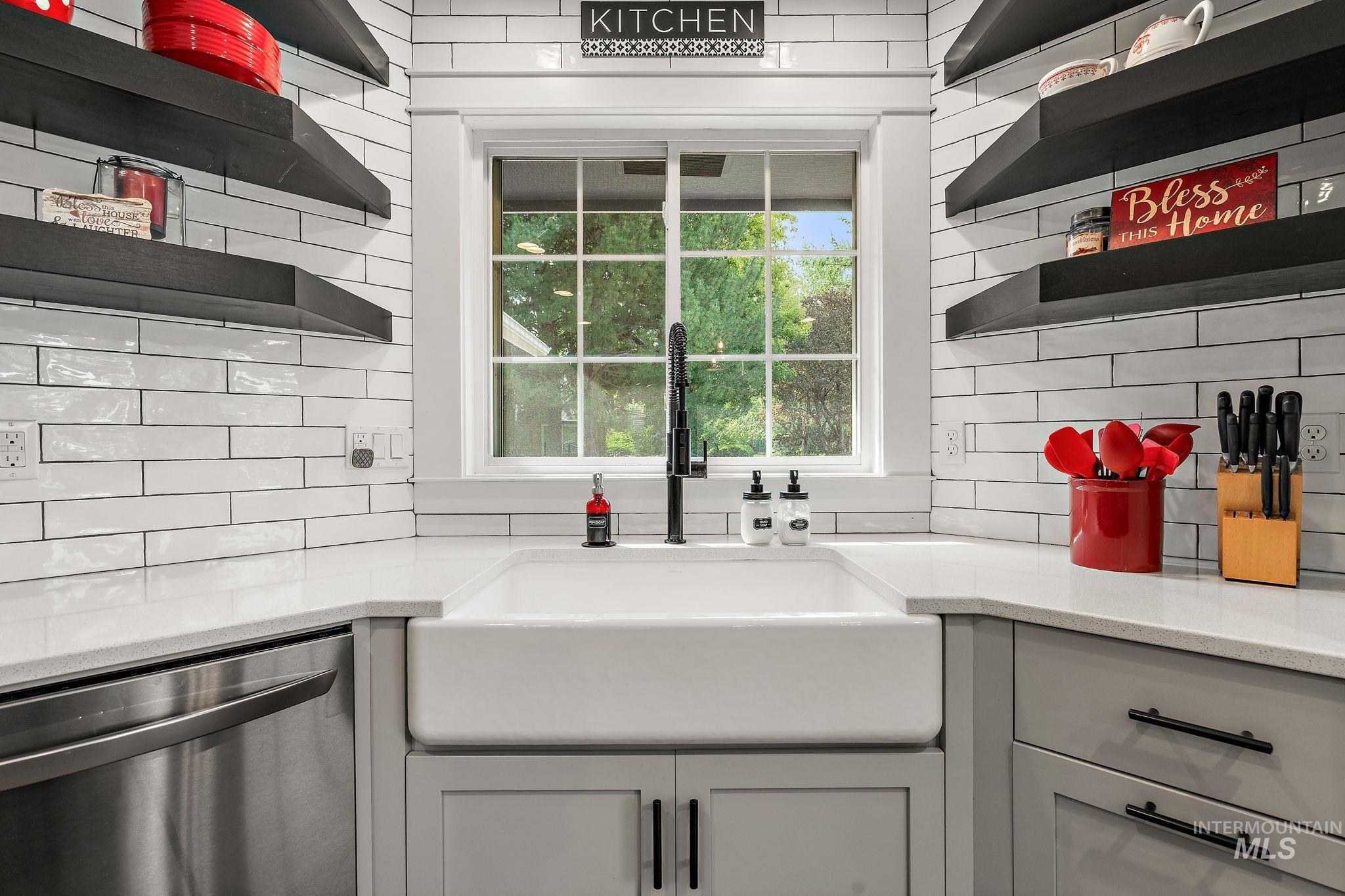 5363 North Hickory Run Place Boise, ID 83713 - Photo 11 of 50 Kitchen featuring open shelves, stainless steel dishwasher, light stone counters, gray cabinetry, and backsplash