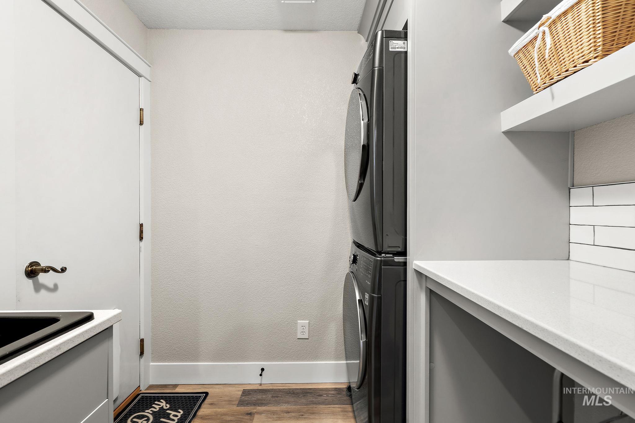 5363 North Hickory Run Place Boise, ID 83713 - Photo 18 of 50 Laundry room with stacked washer and clothes dryer and light wood-style floors