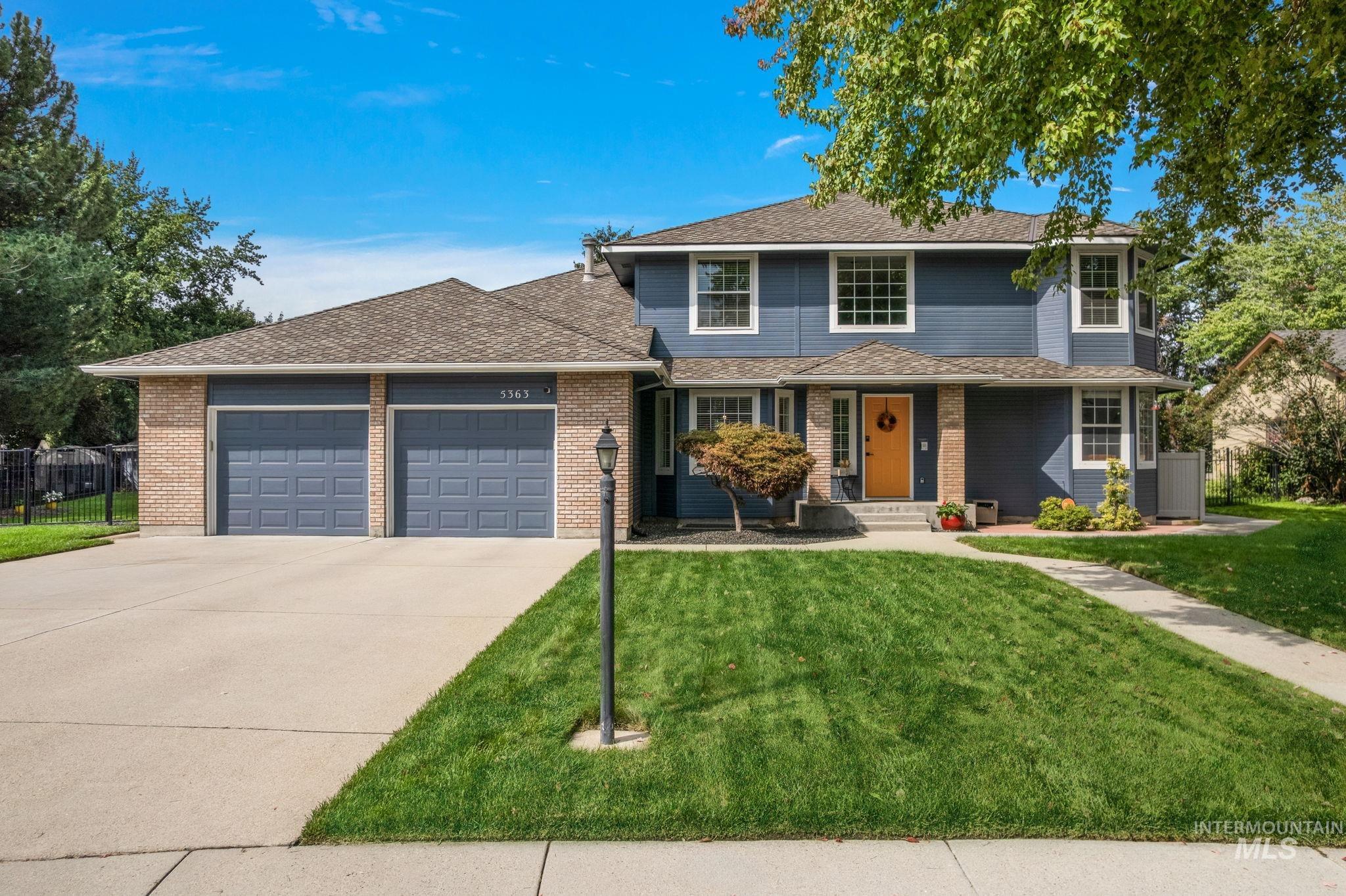 5363 North Hickory Run Place Boise, ID 83713 - Photo 2 of 50 Traditional home featuring covered porch, concrete driveway, an attached garage, roof with shingles, and brick siding