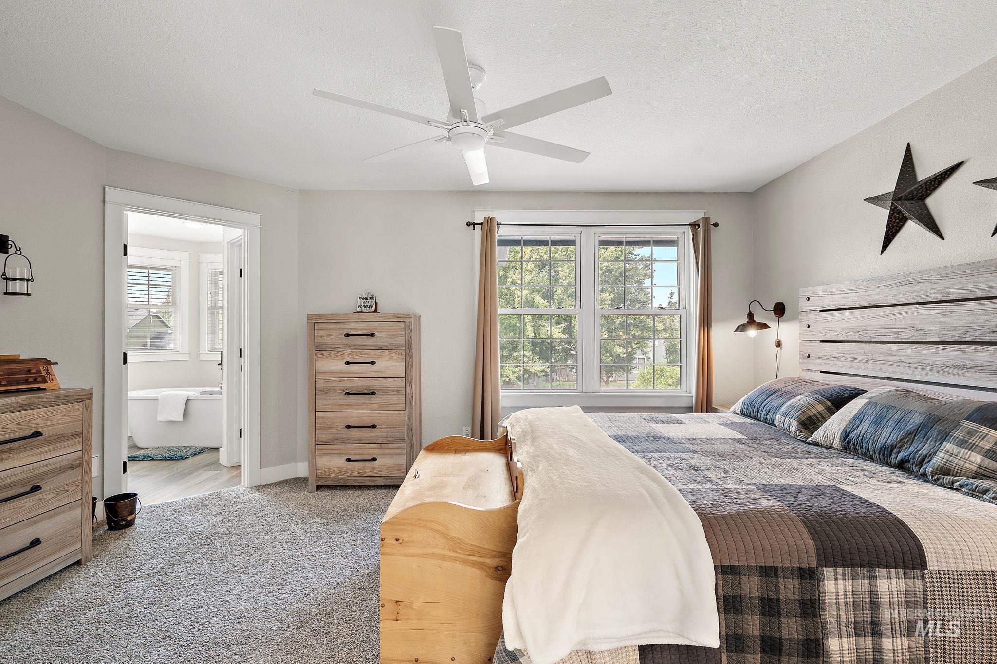 5363 North Hickory Run Place Boise, ID 83713 - Photo 22 of 50 Bedroom with ensuite bath, light colored carpet, and a ceiling fan