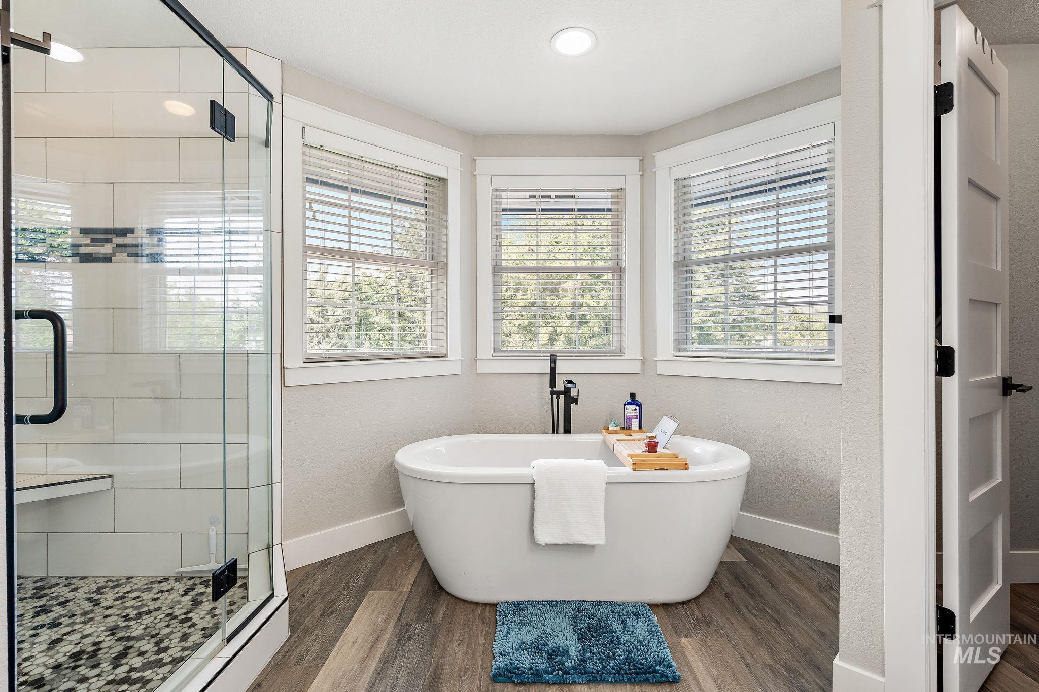 5363 North Hickory Run Place Boise, ID 83713 - Photo 25 of 50 Bathroom with a soaking tub, a stall shower, and dark wood finished floors