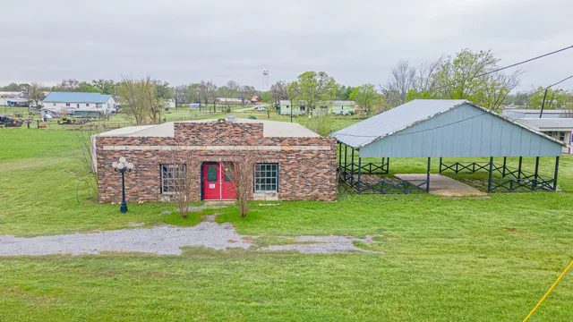 a aerial view of a house with a big yard and large trees