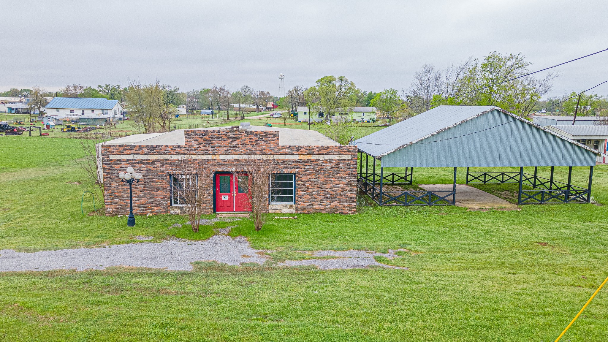 a aerial view of a house with a big yard and large trees