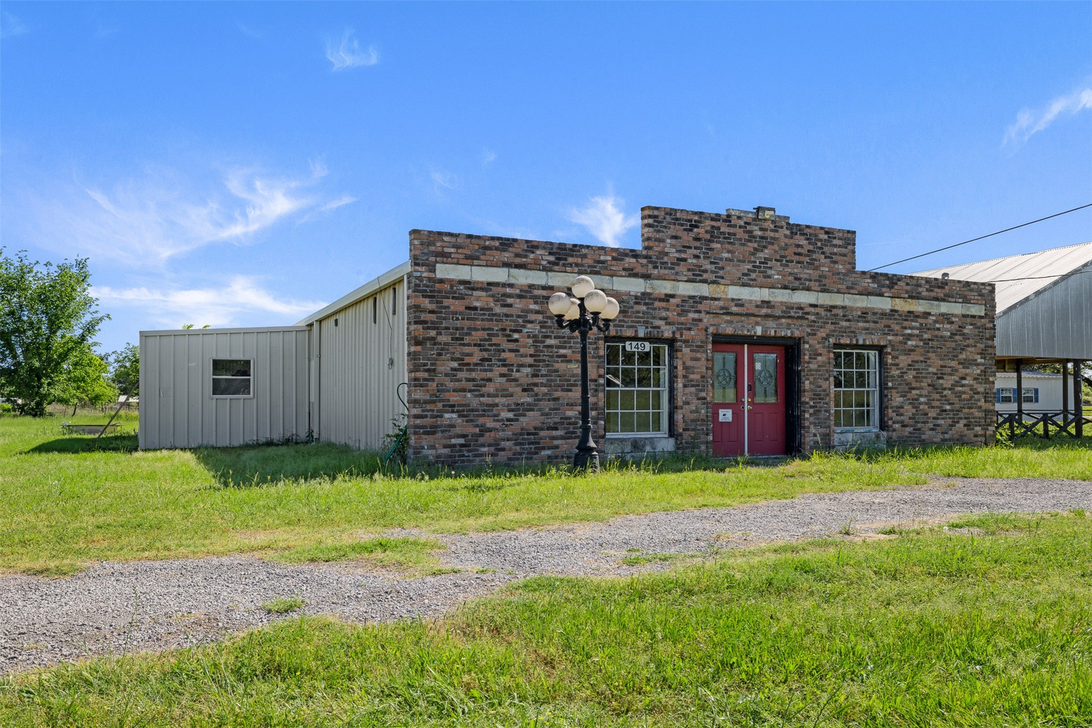447 North Commerce Street Marquez, TX 77865 - Photo 11 of 27 a view of a house with a yard and pathway