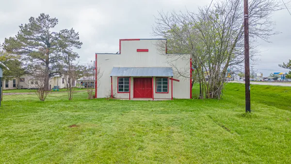 a view of house with outdoor space and garden