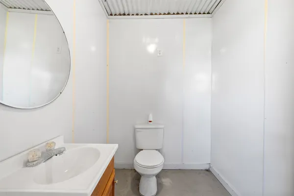 a white toilet sitting next to a white sink