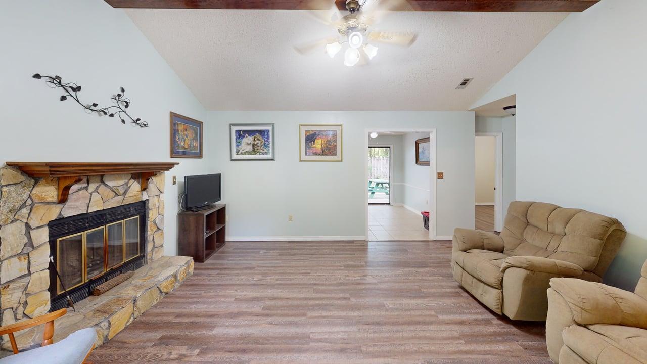 118 Fairoaks Drive Crestview, FL 32539 - Photo 3 of 23 a living room with furniture a fireplace and a flat screen tv