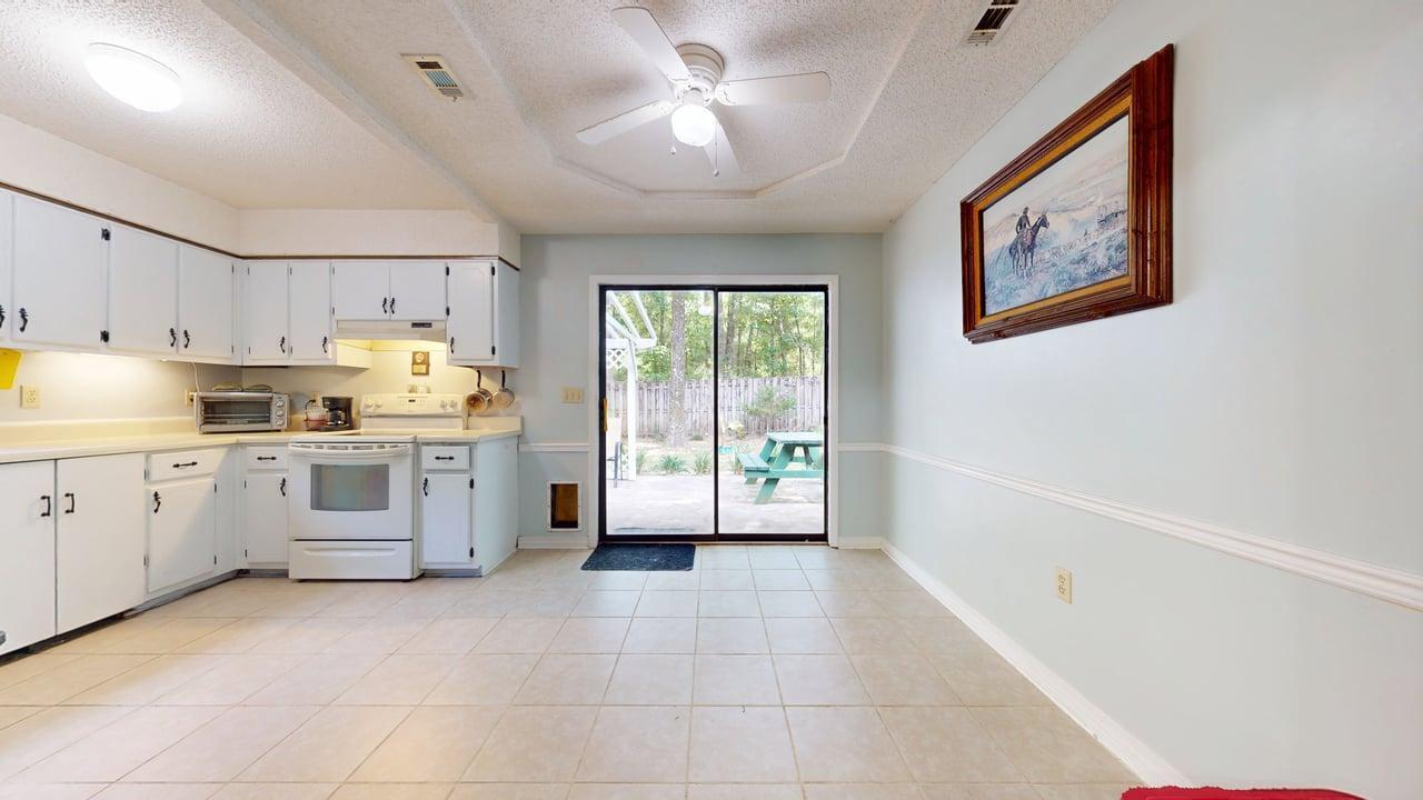 118 Fairoaks Drive Crestview, FL 32539 - Photo 8 of 23 a open kitchen with cabinets and window